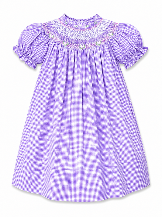 A lavender and white gingham baby dress with short puff sleeves, a smocked bodice, and embroidered pearl details around the neckline, shown against a plain white background.