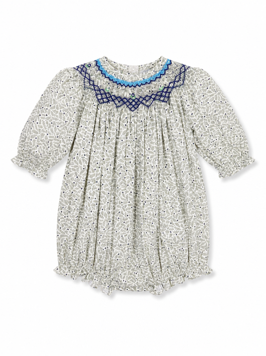 A baby girl's long-sleeve smocked dress with a white and gray floral print, featuring a blue crocheted collar.